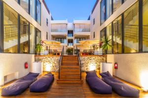 a building with purple pillows on the side of it at Penthouse 13 - One Bay Residence with private rooftop terrace and dip in pool in Pereybere