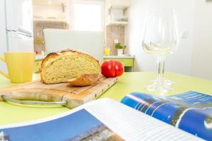 a cutting board with a loaf of bread on a table at Eco Sunshine Apartments Lumbarda in Lumbarda