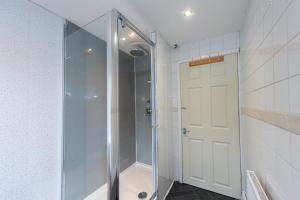 a shower with a glass door in a bathroom at Cedar Room in Liverpool