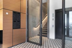 a hallway with a glass door and a tile floor at Blue Viking Apartments Reykjavik in Reykjavík