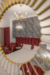a bedroom with a bed and a chandelier at Hotel Vila Central Boutique Satu Mare in Satu Mare