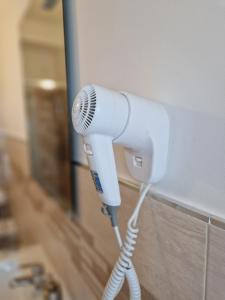 a hair dryer is attached to a wall at B&B Viale San Pietro in Sassari