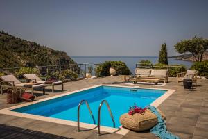 a swimming pool with a view of the ocean at Braunis Horio Villas in Asos