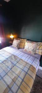 a bedroom with two beds with pillows on it at Stable cottage cozy,quirky with a hot tub in Bridlington