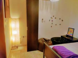 a bedroom with a bed with a purple blanket at Full Apartment in Central Al Ain (All Amenities) in Al Ain