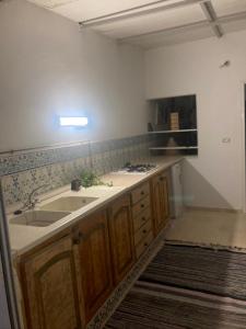 a kitchen with a sink and a stove at Studio Marsa in La Marsa