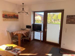 salon ze stołem i telewizorem w obiekcie Ferienwohnung Biermann w mieście Oberammergau