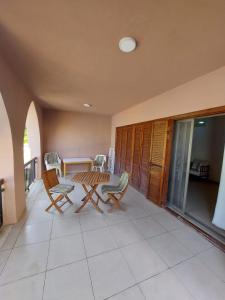 a patio with a table and chairs on a balcony at Ground floor apartment by circular pool in Talabay (sweet coffee apartment) in Aqaba