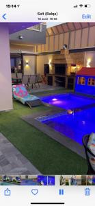 a swimming pool with blue lights in a room at Villa Jana chalet - Private Villa - Dead Sea - Jordan in Ash Shāghūr