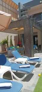 a group of lounge chairs on a patio at Villa Jana chalet - Private Villa - Dead Sea - Jordan in Ash Shāghūr