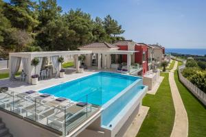 a villa with a swimming pool and a house at Casa Laura - Sky Lounge Villas in Svoronata