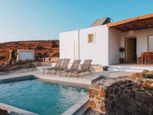 a villa with a swimming pool in front of a house at Livas Residence in Megálon Khoríon