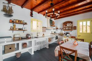 a kitchen with a table and a dining room at Livas Residence in Megálon Khoríon