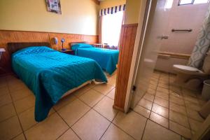 Un pat sau paturi într-o cameră la Hotel Montecarlo