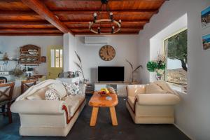 a living room with two couches and a table at Livas Residence in Megálon Khoríon