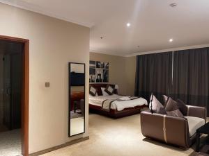 Ένα ή περισσότερα κρεβάτια σε δωμάτιο στο Wakra Inn Hotel Apartments