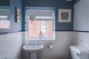 a bathroom with a sink and a window at Corner Cottage - character, charm, great location. in Ringwood +98 photos