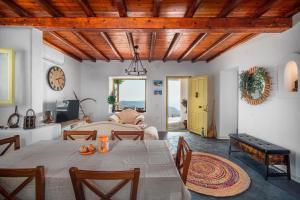 a dining room with a table and a living room at Livas Residence in Megálon Khoríon