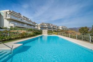 a swimming pool in front of a building at Apartment Harmony in La Cala Golf, Mijas Spain in Málaga