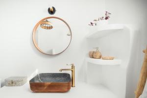 a bathroom with a sink and a mirror at Livas Residence in Megálon Khoríon
