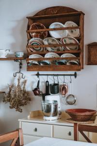 a bunch of plates and utensils hanging on a wall at Livas Residence in Megálon Khoríon