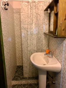 a bathroom with a sink and a shower at Holiday Home Case Blu in Lipari