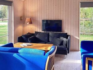 a living room with a couch and a table at 5 person holiday home in V ggerl se in Marielyst