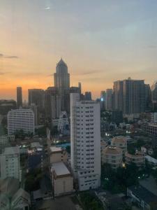 a city skyline with a tall white building at Spacious room 55 sq.m. Central BKK close to Nana BTS in Bangkok