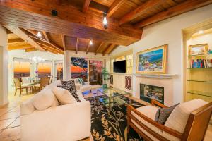 a living room filled with furniture and a fireplace at Cliff Dr View in Laguna Beach