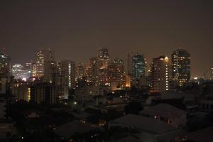 a city skyline at night with lit up buildings at Spacious room 55 sq.m. Central BKK close to Nana BTS in Bangkok