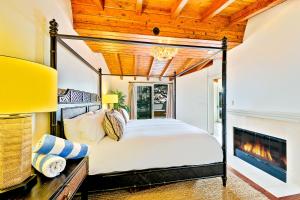 a bedroom with a bed and a fireplace at Cliff Dr View in Laguna Beach