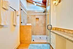 a bathroom with a shower with a glass door at Cliff Dr View in Laguna Beach