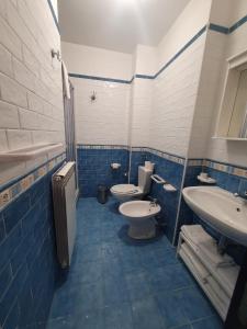 a blue and white bathroom with two toilets and a sink at Le Casette d'Abruzzo in Ateleta +35 photos