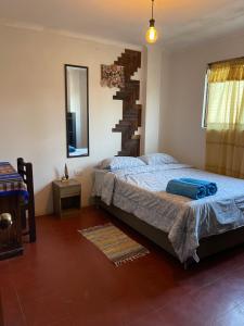 a bedroom with a bed and a spiral staircase at Totora Surf Hostel in Huanchaco +31 photos