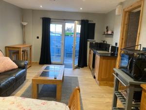 a living room with a couch and a table at Roblins Nest in Ammanford