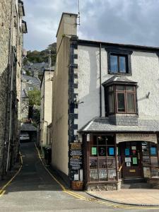 a building on a street with a shop on the side at Flat 2, Ty Newydd in Barmouth