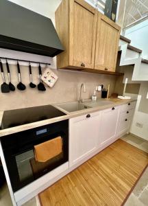 a kitchen with a sink and a stove top oven at Al Bastione del Borgo Saraceno, Varigotti in Varigotti