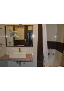 a bathroom with a sink and a mirror at Shining star in Bodh Gaya