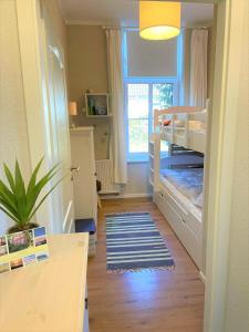 a small room with two bunk beds and a window at Wohnung Luv - Alte Schule in Glowe