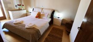 A bed or beds in a room at Vasiliki's Residence - Breathtaking View