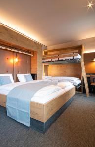 a bedroom with two beds and a bunk bed at RiKu HOTEL Reutlingen in Reutlingen