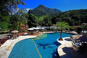 a large swimming pool with a mountain in the background at Eco Resort Serra Imperial in São Pedro da Serra