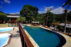 a large swimming pool next to a resort at Eco Resort Serra Imperial in São Pedro da Serra