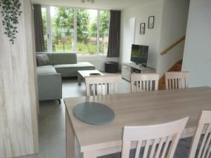 a living room with a table and a couch at Vakantiewoning De Zandkorrel in Middelkerke