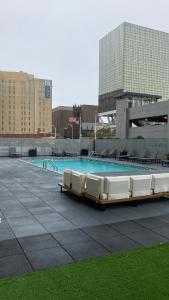 a swimming pool with white chairs in a building at Queen of Charm Luxury Suite Downtown Hartford Location!Location!Location! in Hartford