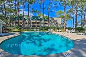 a large swimming pool in front of a building at Bijou De La Beach in Hilton Head Island