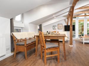 a dining room with a wooden table and chairs at Ferienanlage Poschmann Strohboden in Insel Poel