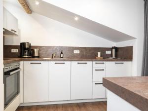 a kitchen with white cabinets and a counter top at Ferienanlage Poschmann Strohboden in Insel Poel