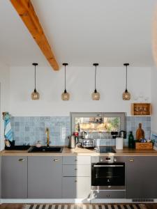 a kitchen with a sink and a stove top oven at Hegyi Kabin - Zebegény in Zebegény