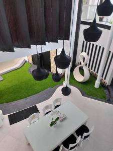 a white table and chairs in a room with a table and a table at Villa Rose in Seminyak +34 photos